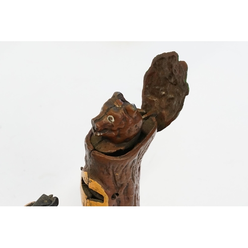 588 - A 20th Century Cast Iron Money Box Toy depicting a Man Shooting a Bear coming out of a tree stump.