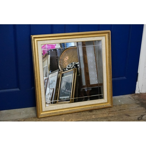 559 - A Gilt Framed Cloth Edged Mirror. Measuring: 77cms x 77cms.