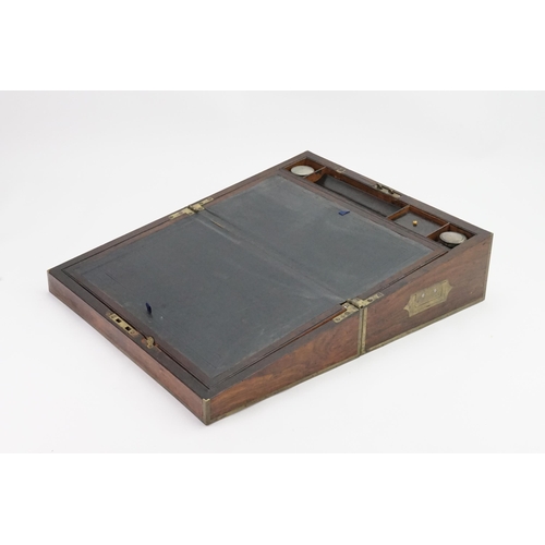 592 - A Brass bound Writing Slope with a fitted interior to include Inkwells, Pen Tray, etc including a Br... 