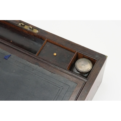 592 - A Brass bound Writing Slope with a fitted interior to include Inkwells, Pen Tray, etc including a Br... 