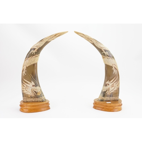 275 - A Pair of Chinese Buffalo Horn Dragon carved Horns on Wooden Bases.