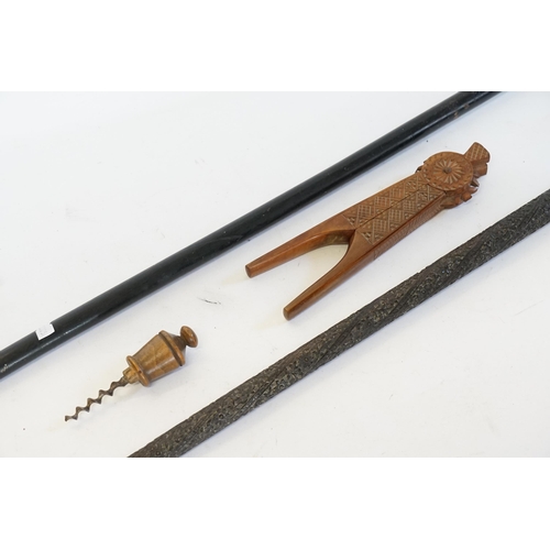 741 - A Carved Indian Walking Stick, a Pair of Chip Carved Yugoslavian Nut Crackers, a Walking Stick & a C... 