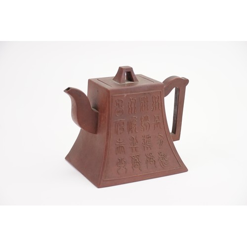 271 - A Yixing Tea Pot decorated with 16 Characters, Angular Handle, a Seal Mark & an A shaped lid.