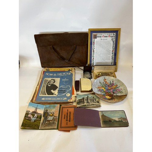 610 - A Silver Mounted Bible, a Safety Pin, Post Cards, a folder & a Satchel.