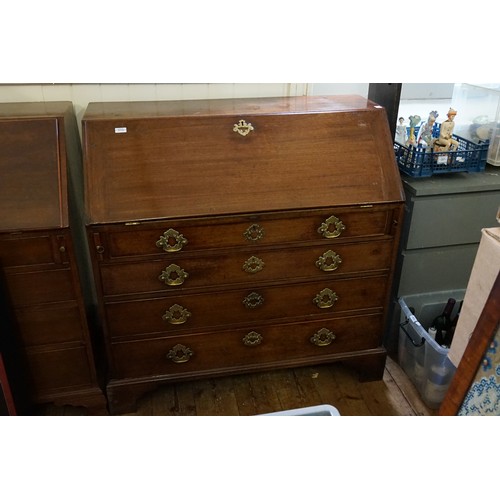 513 - An Antique Mahogany Bureau with a fitted & scroll pattern interior, Four graduated Drawers, Brass Ha... 