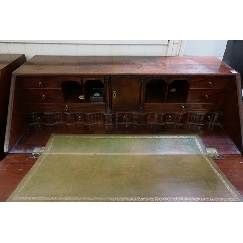 513 - An Antique Mahogany Bureau with a fitted & scroll pattern interior, Four graduated Drawers, Brass Ha... 