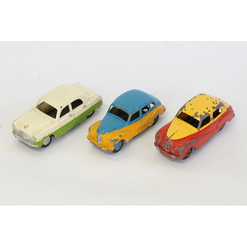 246 - Three 1950s Dinky Models to include an Austin Somerset in Red & Yellow, a Austin Devon in Blue & Yel... 