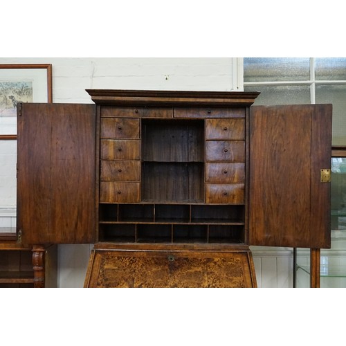 555 - An early 18th Century walnut feather banded and stained field maple bureau bookcase. (Email from Bon... 