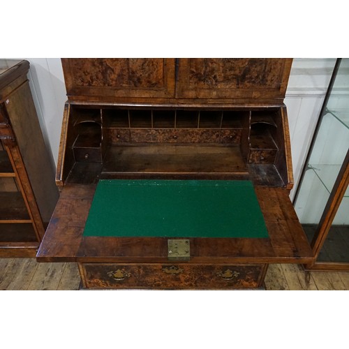 555 - An early 18th Century walnut feather banded and stained field maple bureau bookcase. (Email from Bon... 