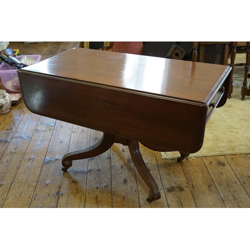 566 - A Late 19th Century Mahogany Drop-Flap Table resting on splayed out & ribbed legs, Castors & a Singl... 