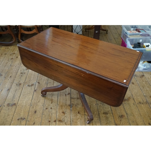 566 - A Late 19th Century Mahogany Drop-Flap Table resting on splayed out & ribbed legs, Castors & a Singl... 