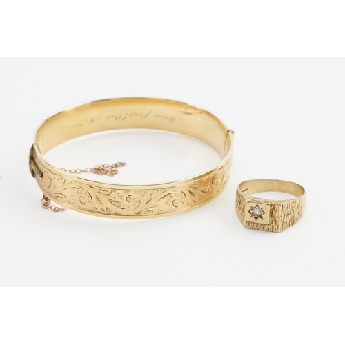 159 - A 9ct Gold ring set with a single paste stone, along with a 9ct Gold core engraved bangle. Weight 33... 