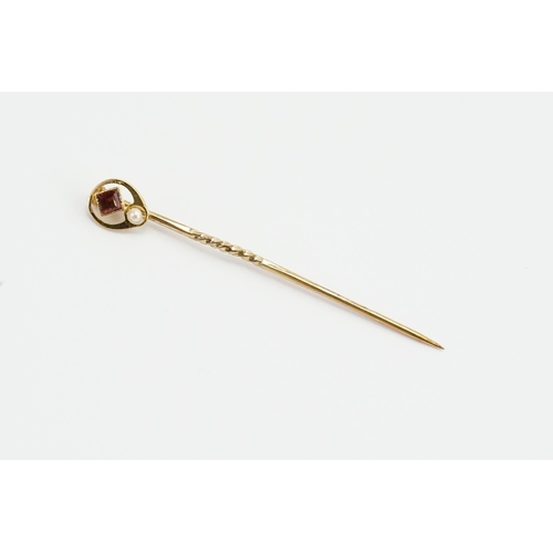 164 - A 15ct marked Ruby and pearl set stick pin. Weight 1.3g