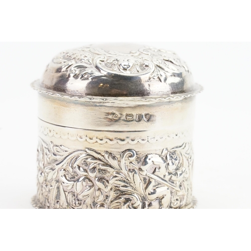 5 - A 1895 William Comyns & Sons Silver embossed trinket pot. Weight 56g. Height 6cm.