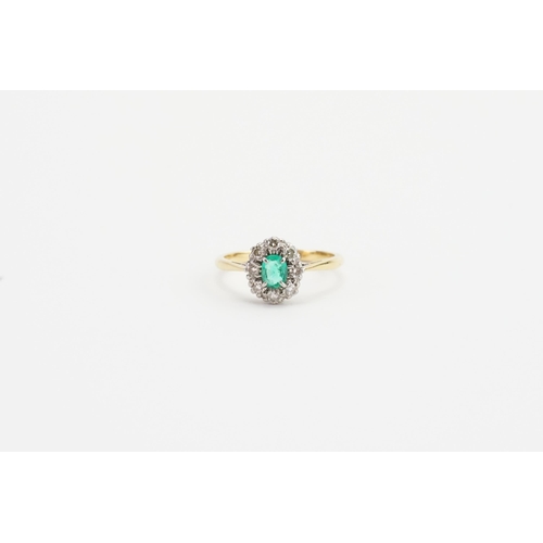 199 - A 18ct Gold and Platinum topped ring, set with a oval cut Emerald and eight 0.03ct surrounding diamo... 