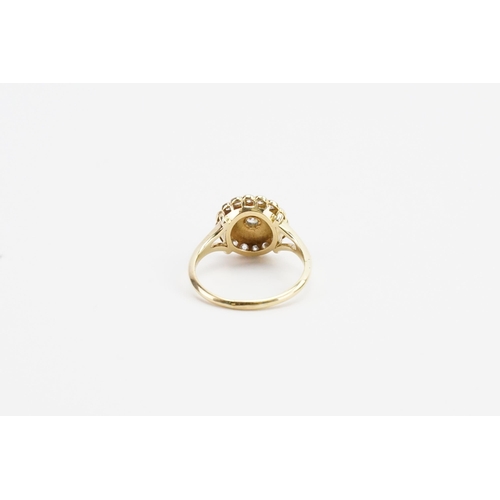 200 - A 9ct Gold diamond and enamel set ring. In the floral design, set with 16 chip diamonds and one slig... 