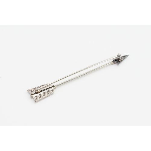 201 - A white gold diamond set arrow brooch (tests as 18ct white gold, as per insurance valuation). The br... 