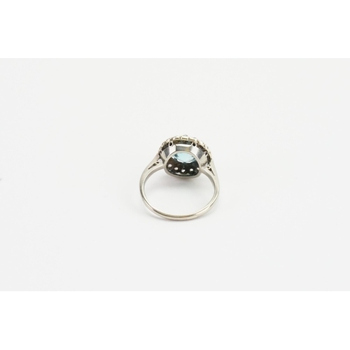 202 - A 9ct white gold cluster style ring, set with a brilliant cut natural bright blue zircon (approx 2.2... 