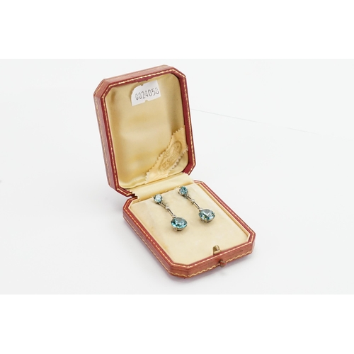 205 - A pair of diamond and zircon set earrings, in the drop design. Set with four zircons (approx 4ct & 0... 