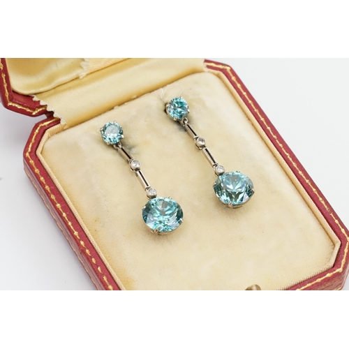 205 - A pair of diamond and zircon set earrings, in the drop design. Set with four zircons (approx 4ct & 0... 