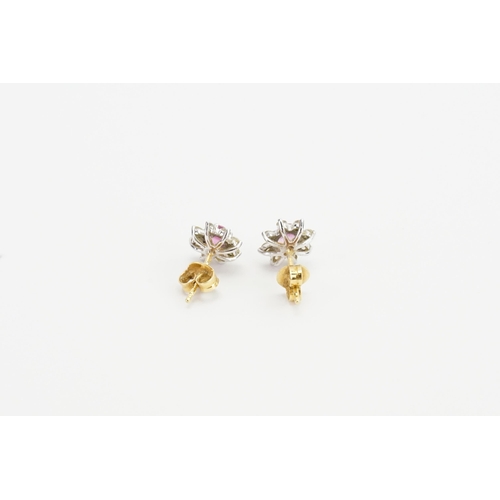 230 - A pair of 18ct gold diamond and pink sapphire earrings, in the floral design, set with eight diamond... 