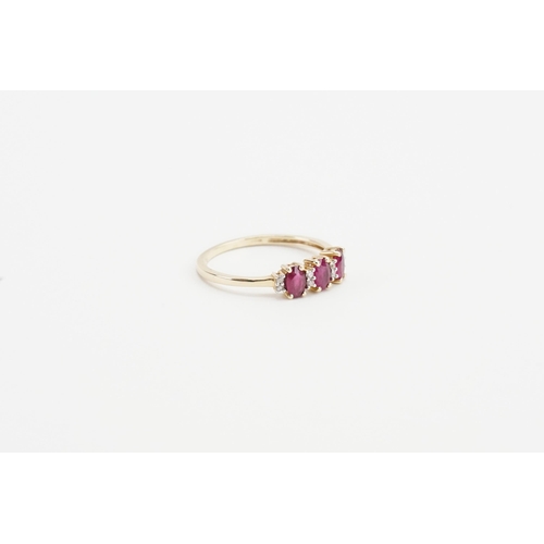 233 - A 9ct yellow gold ruby and diamond set ring, set with 3 oval cut ruby stones and eight chip diamonds... 