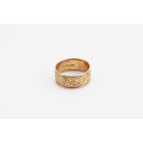 220 - A 9ct gold Chester marked wedding band, with floral decoration. Weight 5.3g. Size U.