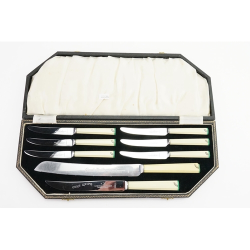 131 - A cased set of art deco cream & green handled cutlery.