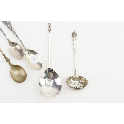 99 - A silver sifter spoon, and a ER commemorative silver spoon, along with others.