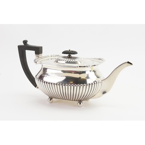 62 - A 1916 Goldsmiths & Silversmiths Sheffield silver teapot, flush hinge cover, and ball feet. Weight 8... 