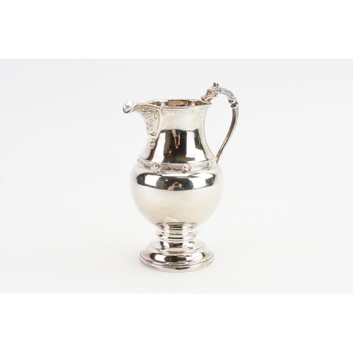 68 - A 1960 Adie Brothers Ltd silver cream jug, with decorated edge and dragon handle. Weight 138g.