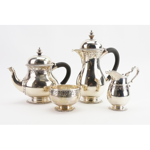 81 - A 1919 Wakely & Wheeler silver tea & coffee service, to include sugar and cream. Decorated with bead... 