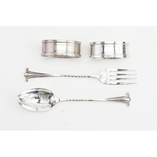 92 - A pair of silver napkin rings, along with a christening spoon and fork. Weight 57g.