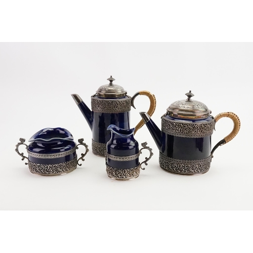 108 - A 1893 Doulton Lambeth Royal blue and silver mounted coffee and tea set, mounted in silver with make... 