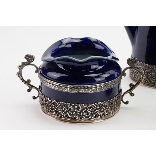 108 - A 1893 Doulton Lambeth Royal blue and silver mounted coffee and tea set, mounted in silver with make... 