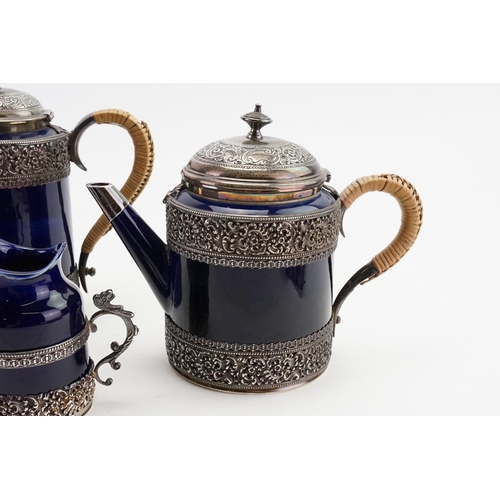 108 - A 1893 Doulton Lambeth Royal blue and silver mounted coffee and tea set, mounted in silver with make... 