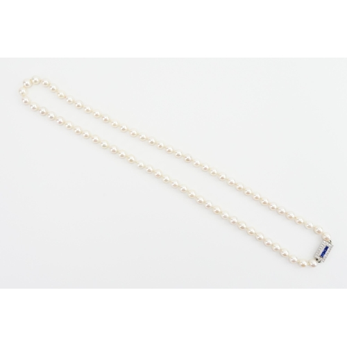 247 - A 15ct white gold diamond and sapphire clasp, strung with pearls. Contained in fitted case. The clas... 