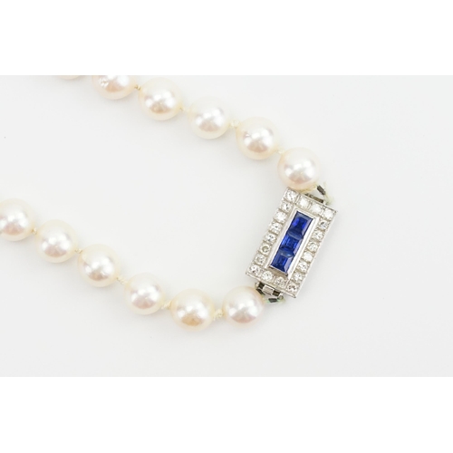 247 - A 15ct white gold diamond and sapphire clasp, strung with pearls. Contained in fitted case. The clas... 