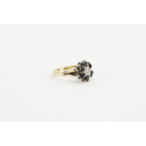 244 - A 9ct gold diamond and sapphire ring, in the cluster form. Size O. Weight 3.5g