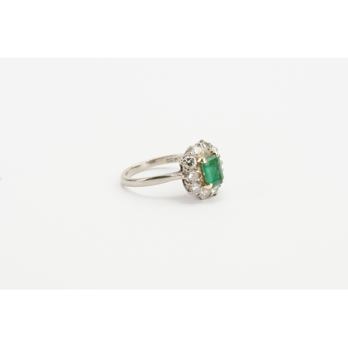 245 - A 18ct white gold diamond and emerald (6.8mm x 5.1mm) set ring. Set with 10 0.09ct diamonds. Size M.... 