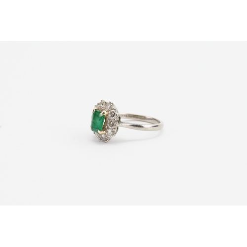 245 - A 18ct white gold diamond and emerald (6.8mm x 5.1mm) set ring. Set with 10 0.09ct diamonds. Size M.... 