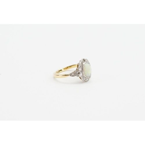 254 - A 18ct yellow gold opal and diamond ring, set with 12 diamonds. Weight 3.2g. Size L.