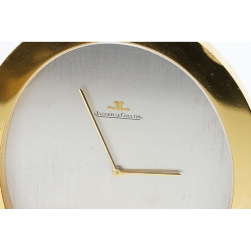 343 - A Jaeger Lecoultre oval table clock 5551, with gold gilt frame & silver coloured face. Contained ins... 