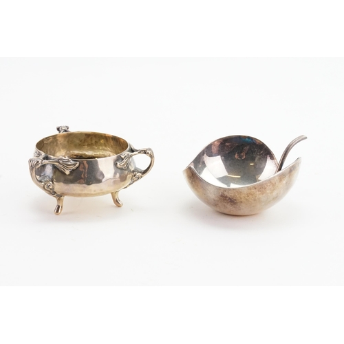 112 - A silver hand beaten condiment pot, along with a silver plated christofle leaf pot.