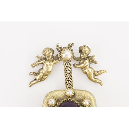 225A - A 1950's Christian Dior Mitchel Maer Gold plated musical brooch, desinged with cherubs. Set with fau... 