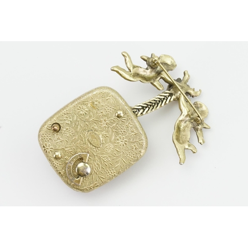 225A - A 1950's Christian Dior Mitchel Maer Gold plated musical brooch, desinged with cherubs. Set with fau... 