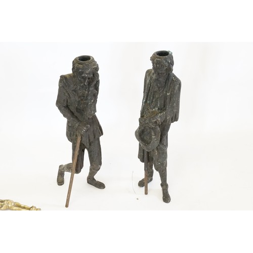 855A - A Pair of Spelter made Candlesticks depicting rich & poor men along with a pair of Fire Irons.