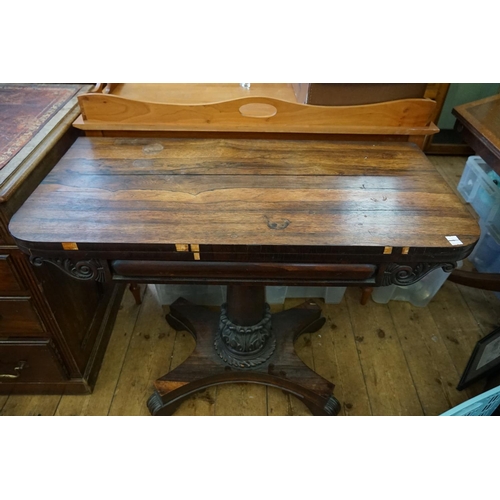 551 - A Regency Fold-over top and Baize Card Table resting on a shaped base.