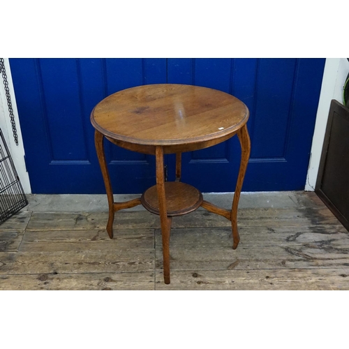 553 - An Edwardian Oak circular topped Drawing room table resting on a shaped base & resting on a jardiniè... 