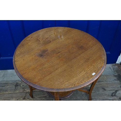 553 - An Edwardian Oak circular topped Drawing room table resting on a shaped base & resting on a jardiniè... 